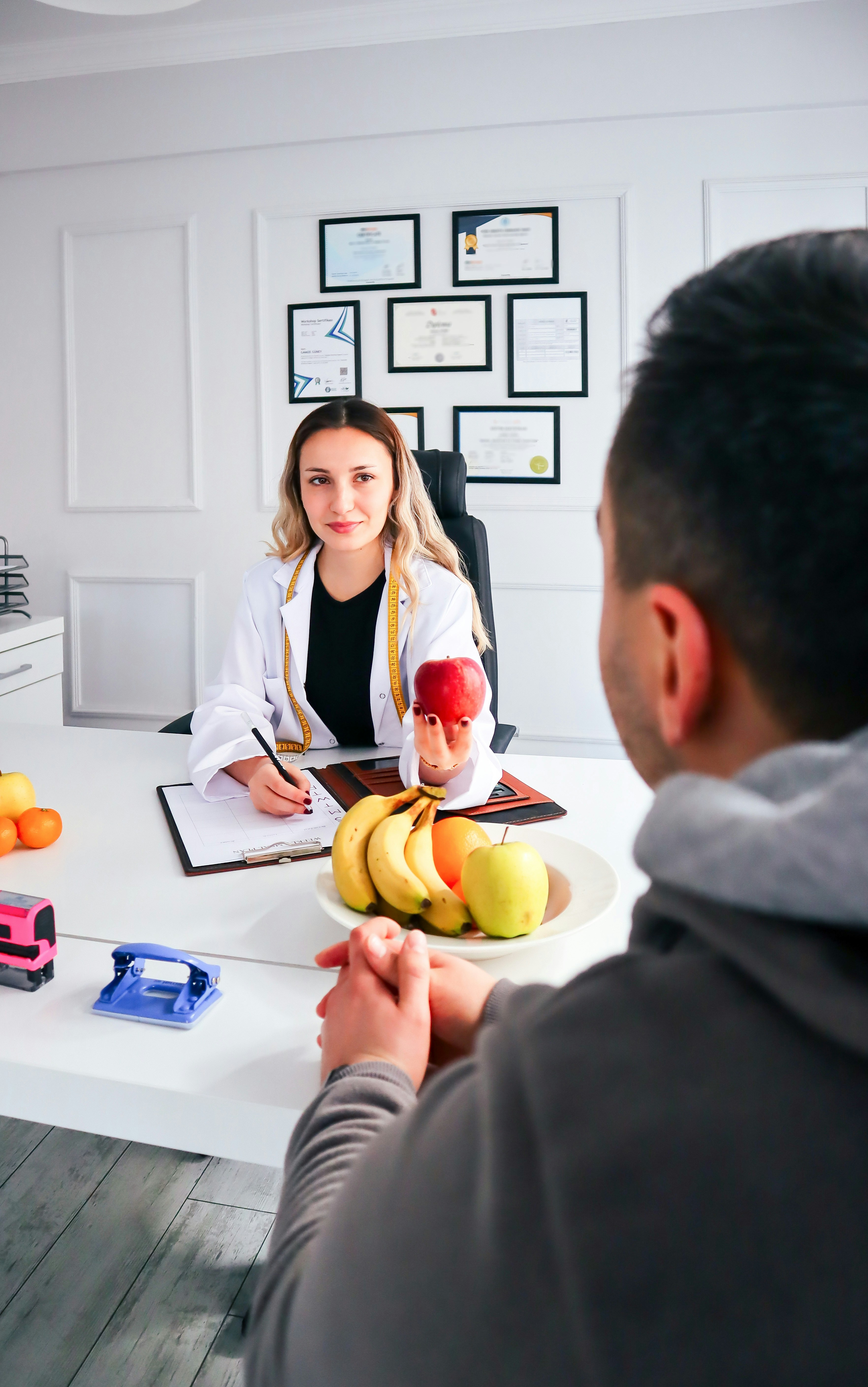 Confident female health coach consulting with client