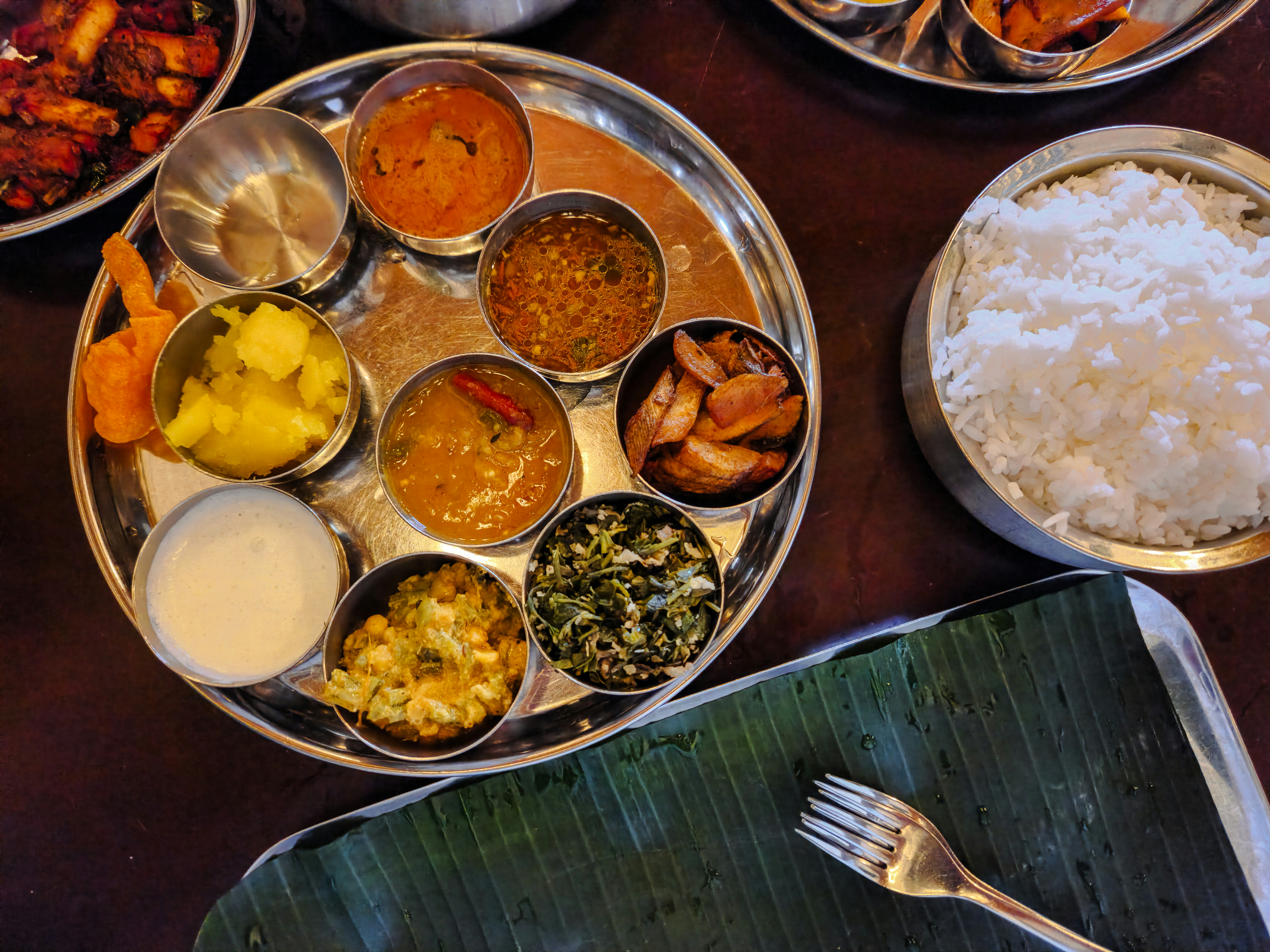 Colorful Indian thali with rice, dal, sabzi, salad, and curd