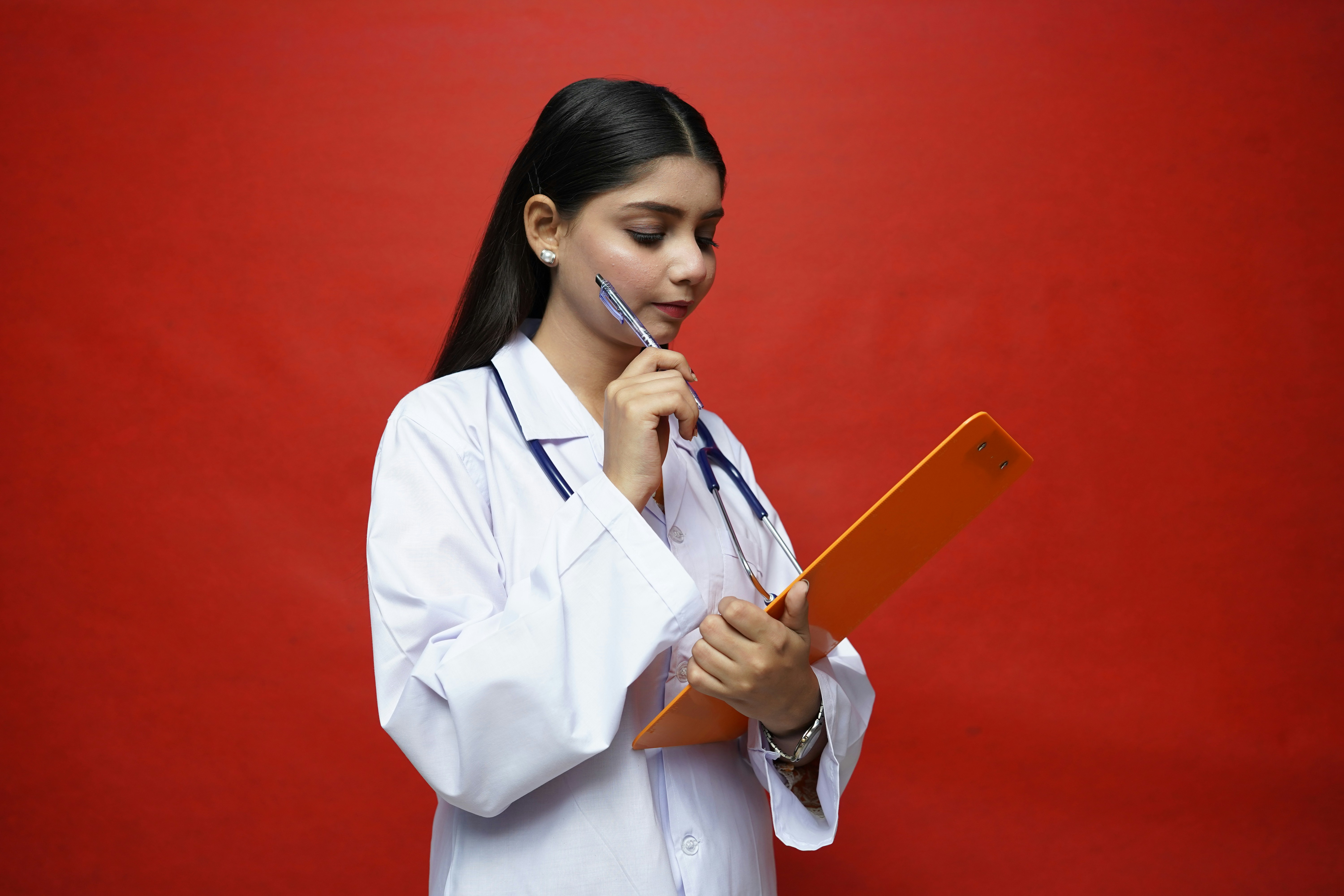 Woman holding medical lab reports looking thoughtful